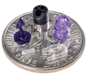 t of various micromolded parts sitting atop a dime show the complexity and precision of the micromolding process.