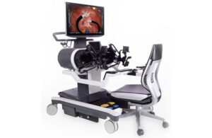 Titan Medical's Enos surgical robot workstation for the surgeon, featuring handheld controls and a display screen
