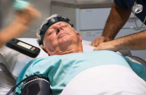 A hospitalized patient wearing a Ceribell headband for monitoring brain activity.