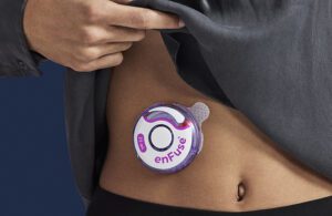 A patient wears the Enable Injections disc-shaped Enfuse device on their stomach. The company had one of the biggest medical device VC deals of 2022. 