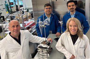 Washington University researchers John Cirrito, Rajan Chakrabarty, Joseph Puthussery and Carla Yuede stand with the SARS-CoV-2 wet cyclone aerosol sampler they developed.