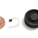 A tiny wireless charging system developed by Resonant Link with a penny for scale.