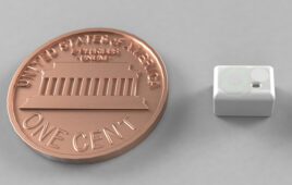 Lura Health's tiny saliva sensor is a small, rectangular device with rounded corners, smaller than a U.S. penny (which is also pictured for scale)